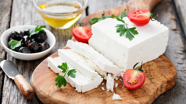 feta cheese sliced up on cutting board