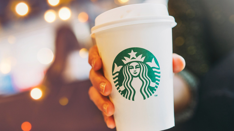 Tall Starbucks coffee cup with lid