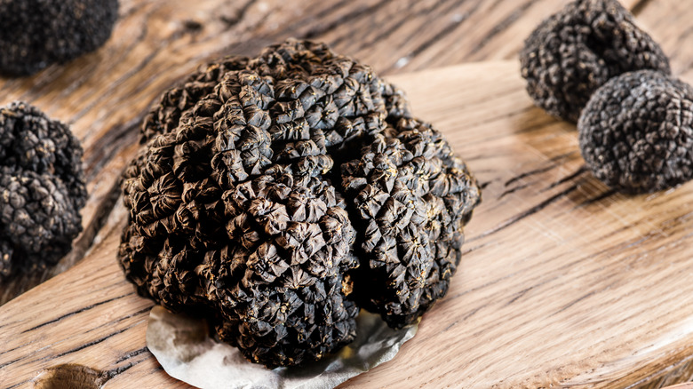 Black truffle on wooden board
