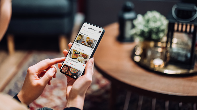 Person ordering food delivery in a mobile phone app
