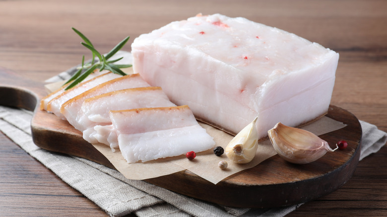 Pork fatback with spices served on a table.