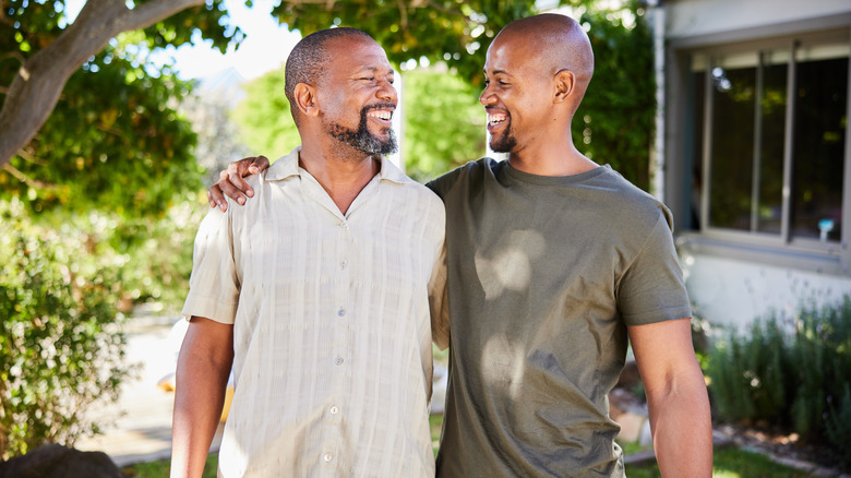 dad and adult son laughing