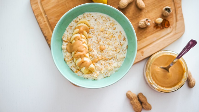 birds eye view of oatmeal bowl with peanut butter jar