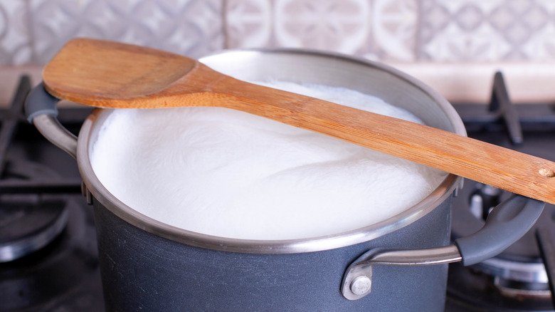 milk boiling in pot on stove