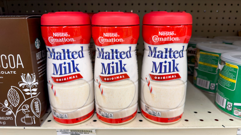 Containers of malted milk on a store shelf