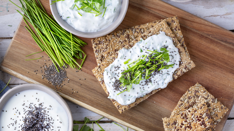 sour cream spread on crispbreads on cutting board