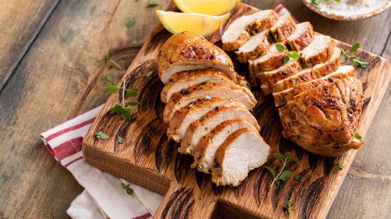 Cooked sliced chicken breasts on a board
