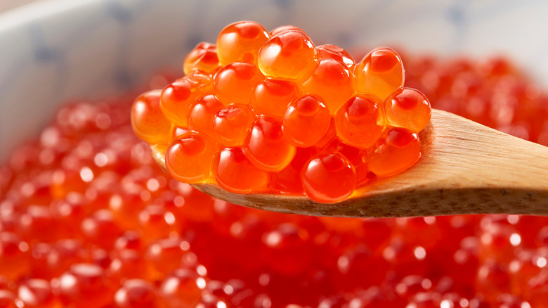 Salmon roe on wooden spoon