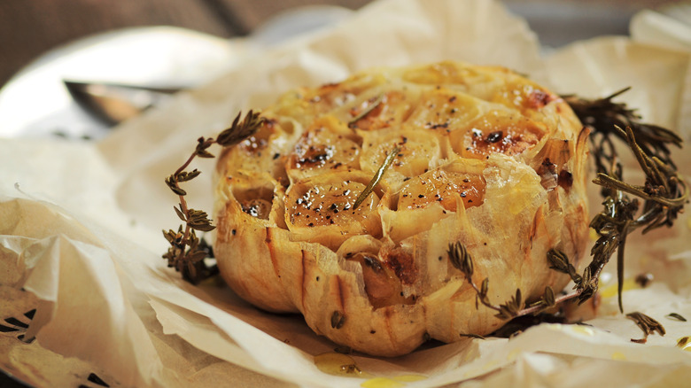 roasted garlic head with herbs