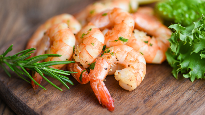 cooked shrimp on wooden board