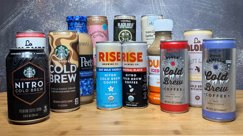 A collection of canned coffees on a wooden table with a white and blue background