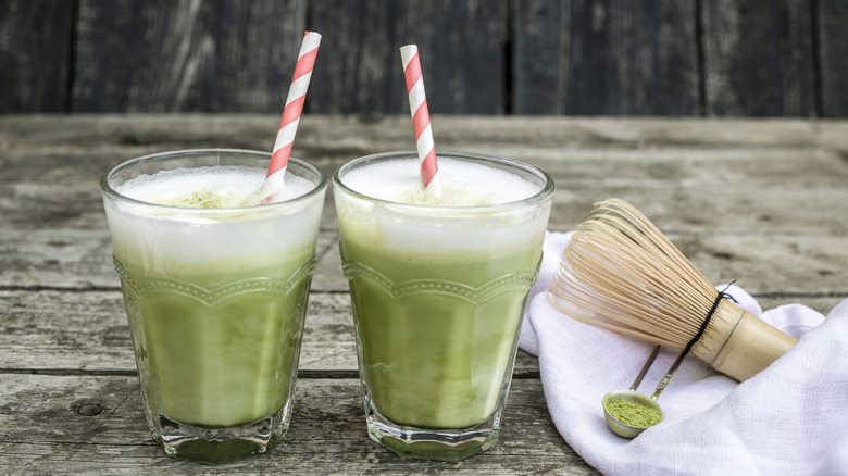 Two glasses of matcha with swirled straws