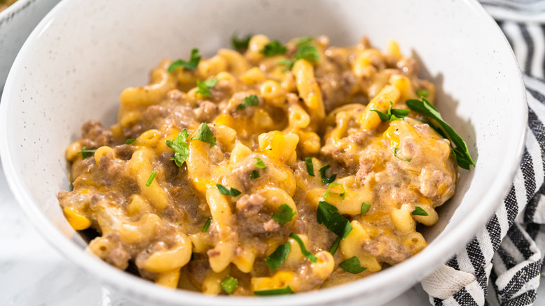 Homemade Hamburger Helper in a white bowl placed on a marble table