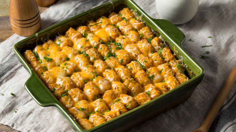 Tater tot casserole in a green dish on a table