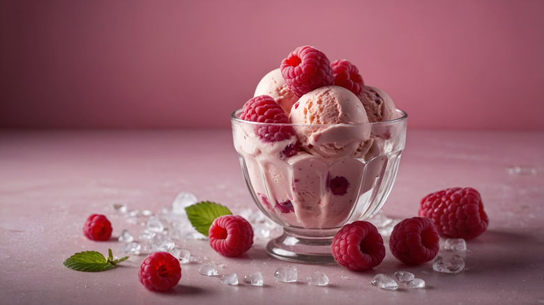 Glass cup of frozen custard with raspberries