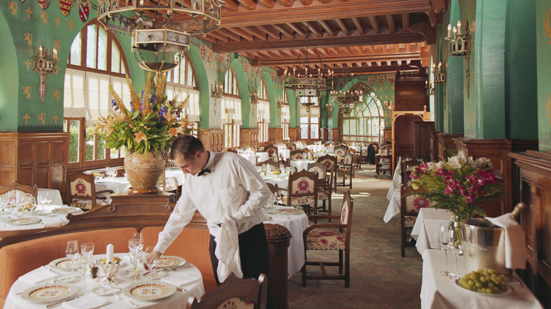 Server setting table in French restaurant