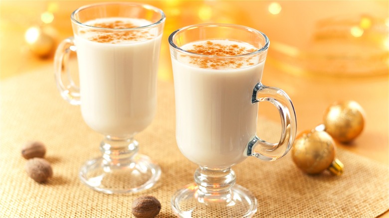 2 glass mugs of eggnog 