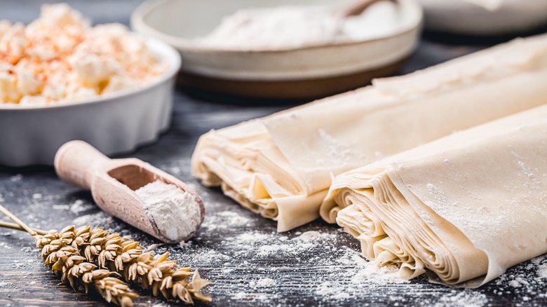 Phyllo dough on countertop with flour