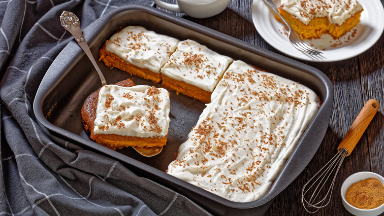 pumpkin cake with frosting in a metal sheet pan