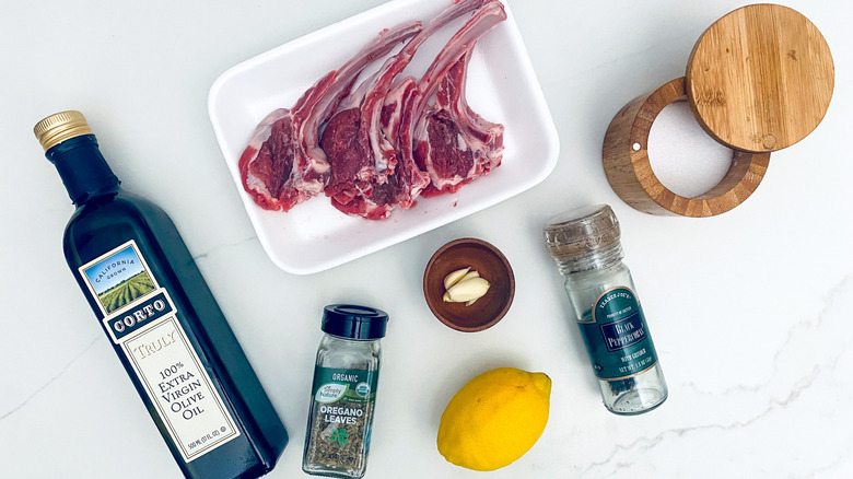Greek-style lamb chop ingredients on marble counterop