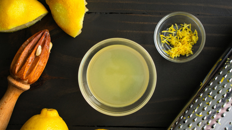 Freshly squeezed lemon juice and zest in glass bowls