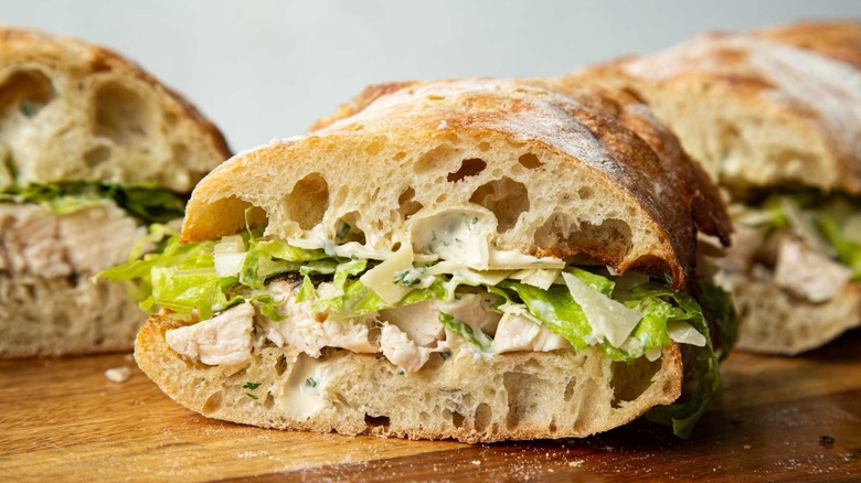 Chicken sandwiches with lettuce on a wooden board