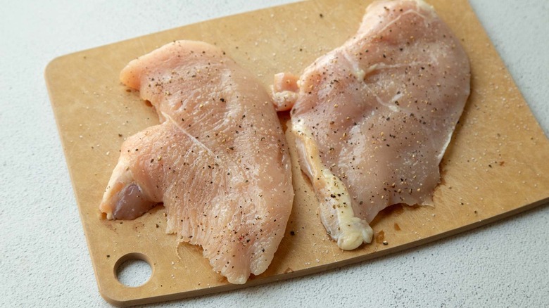 Raw chicken on chopping block