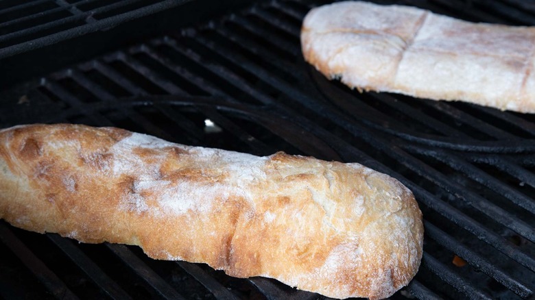 Split bread loaf on a gas grill