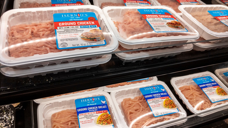 grcoery store fridge with ground chicken packages