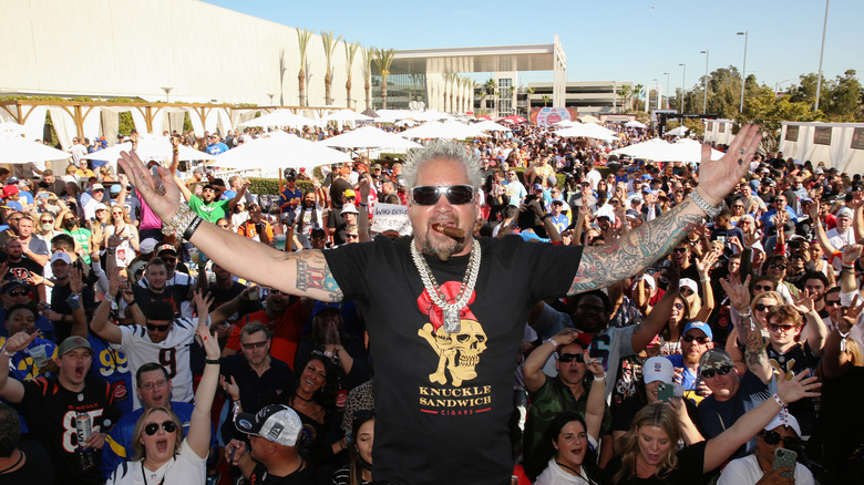 Guy Fieri posing with crowd at a talilgate