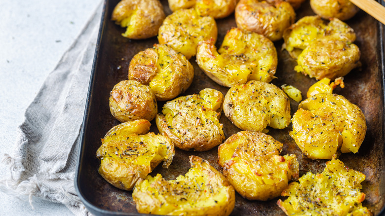 smashed potatoes arranged on baking tray