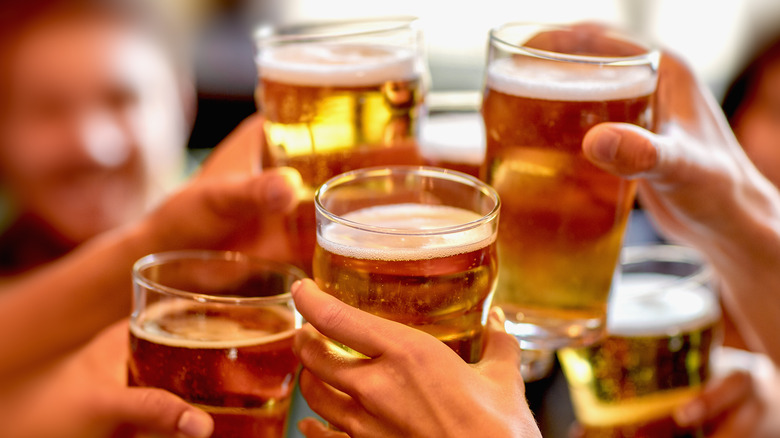 group raising glasses of beer