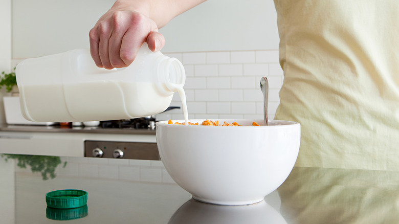 Pouring milk into cereal bowl