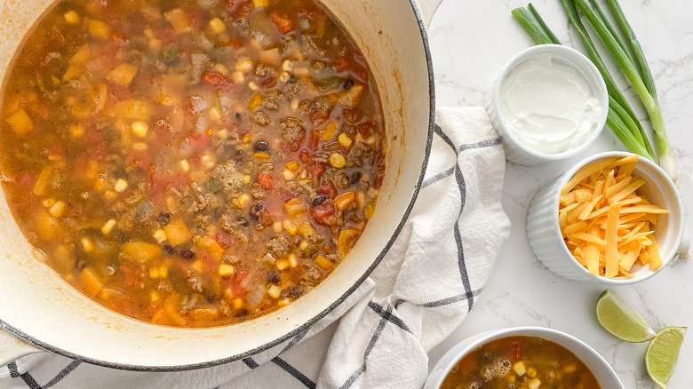 taco soup in large pot sour cream cheddar cheese green onions