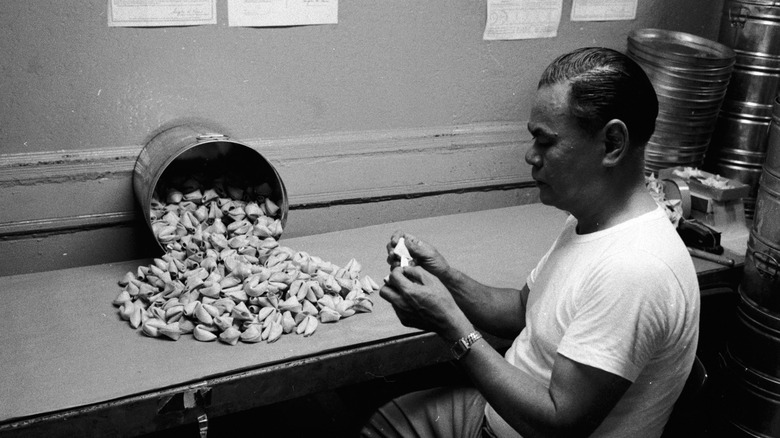 A man holding a fortune cookie