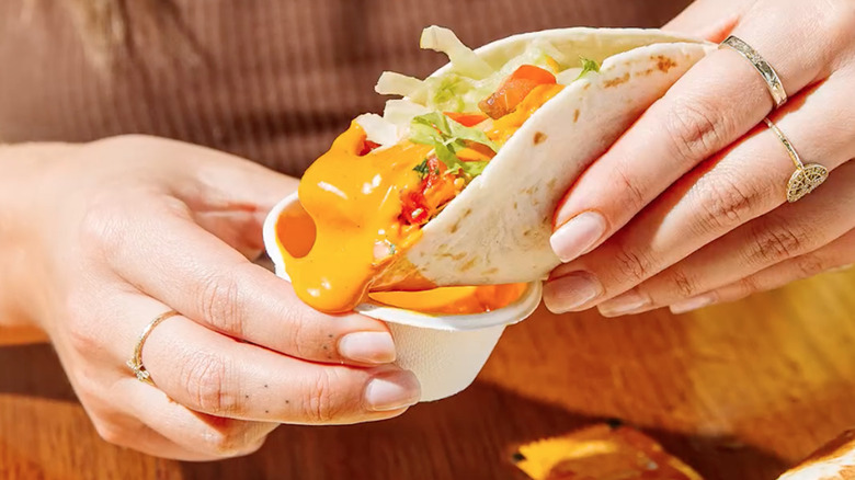 Taco dipped into lava sauce