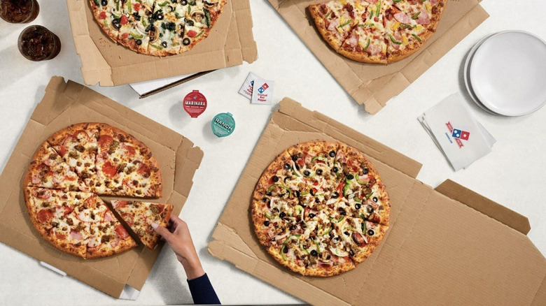 sliced Domino's pizzas in boxes