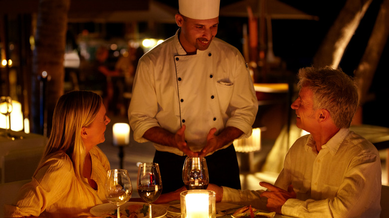 couple speaking with the chef
