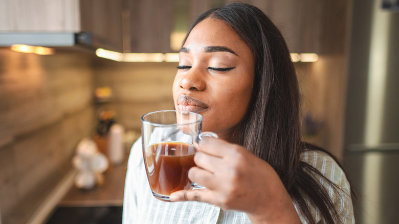 Woman enjoying a cup of freshly brewed coffee 