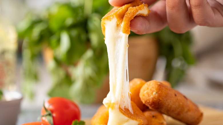 Someone grabbing mozzarella sticks