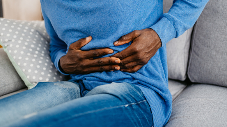 Person holding an upset stomach