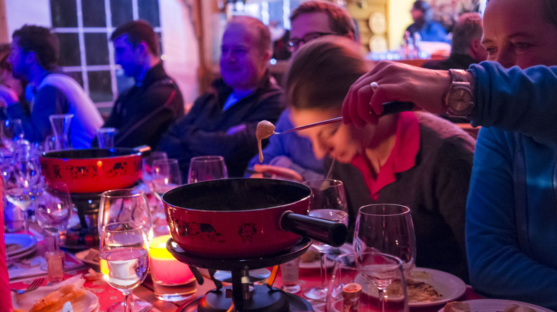 Man twirling fondue fork