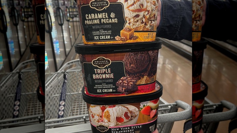 Three half gallon sized Private Selection ice cream tubs in a variety of flavors in the Kroger grocery aisle
