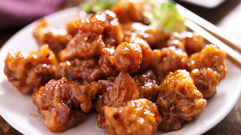 A plate of glistening orange chicken.