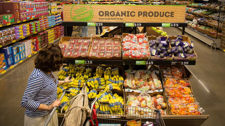 woman shopping for bananas at Aldi's produce section