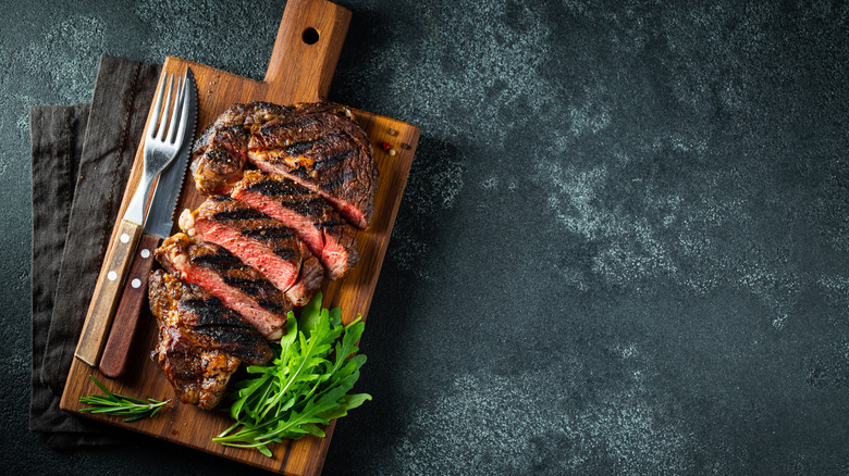 sliced ribeye on cutting board