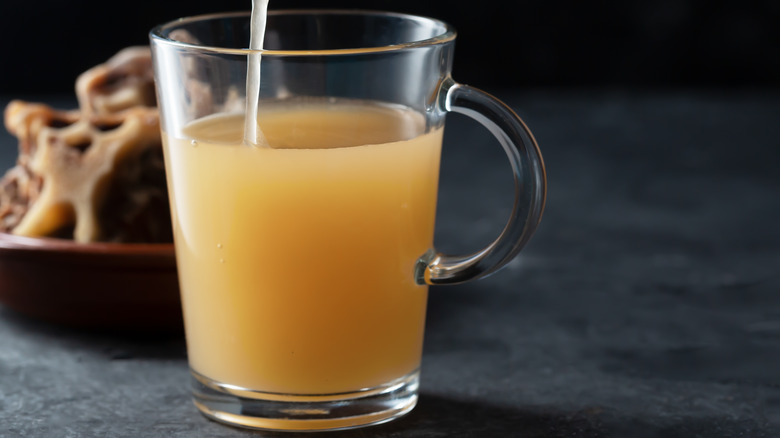 Broth pouring into a cup