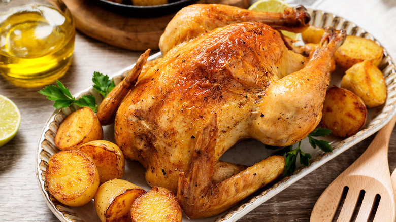 Roasted chicken potatoes in tray on table