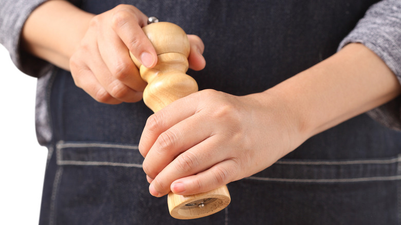 Chef grinding pepper