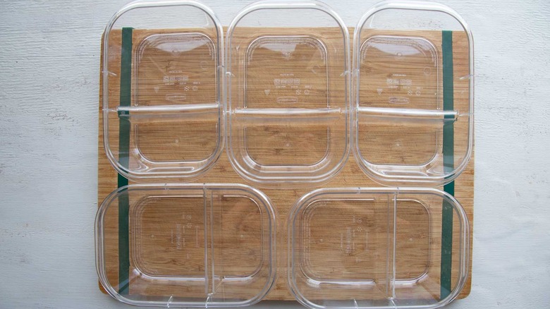 five meal prep containers on counter